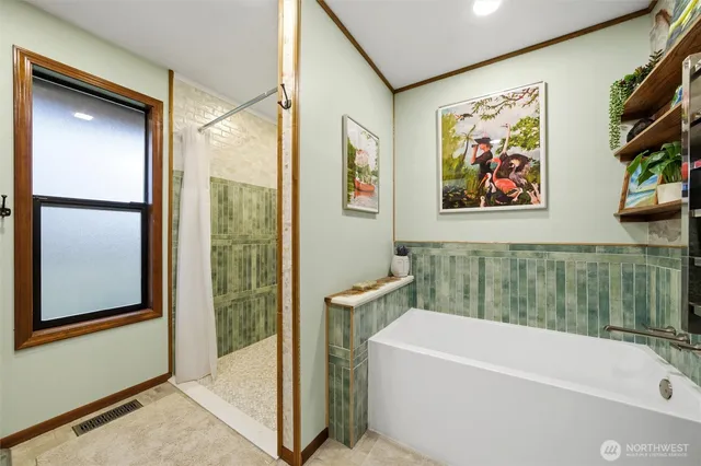 a bathroom with a bathtub and a shower