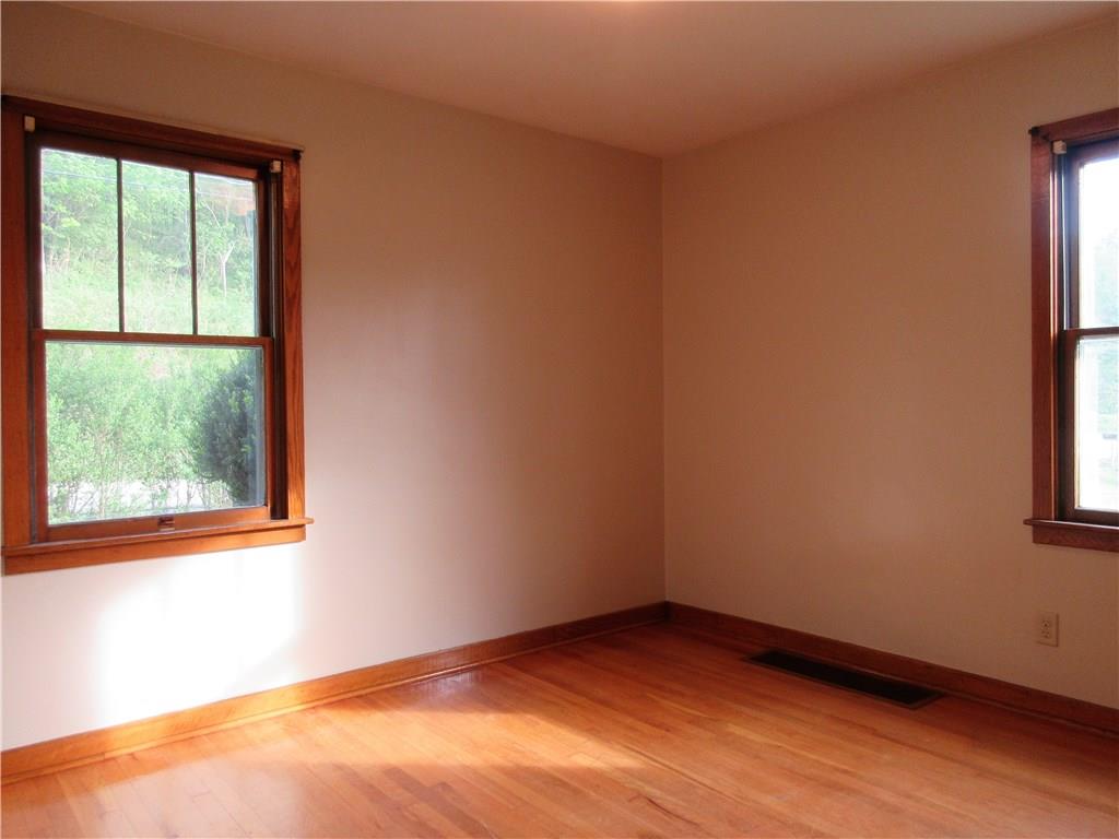 113 Ford City Road Freeport, PA 16229 - Photo 13 of 25 Bedroom 2 features fresh paint, hardwood floors, wood baseboard and window trim and plenty of natural light.