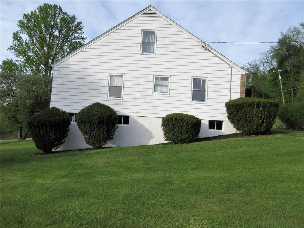 113 Ford City Road Freeport, PA 16229 - Photo 20 of 25 Side view of home with freshly painted block and landscaping.