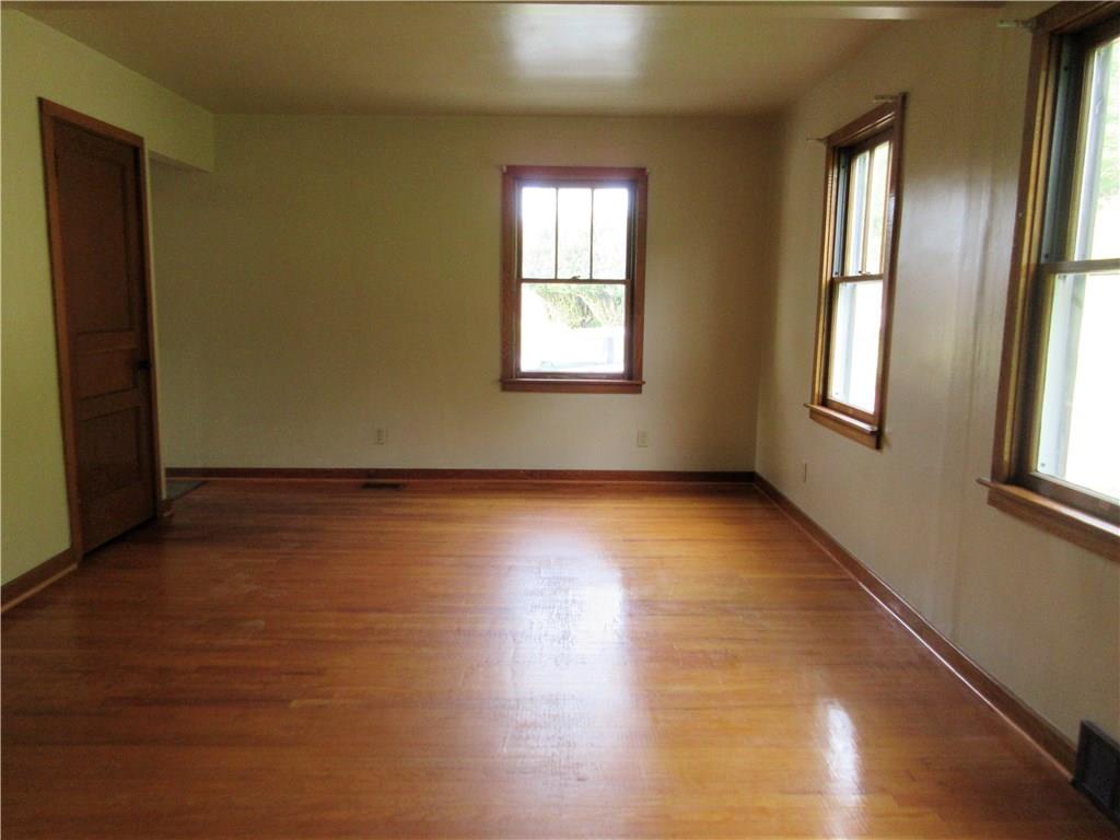 113 Ford City Road Freeport, PA 16229 - Photo 4 of 25 The large 20x13' living room has been freshly painted, has a hardwood floor, coat closet, and the wood trimmed windows offer natural light.
