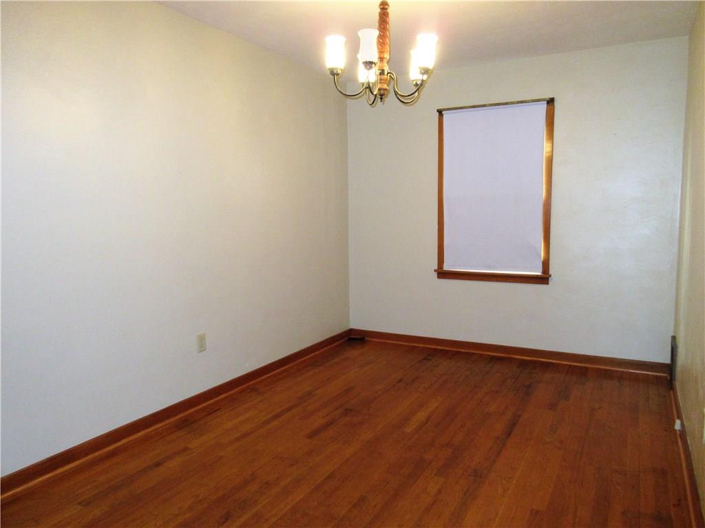 113 Ford City Road Freeport, PA 16229 - Photo 9 of 25 The 14x9' dining room features fresh paint, a hardwood floor, wood trim and a chandelier.