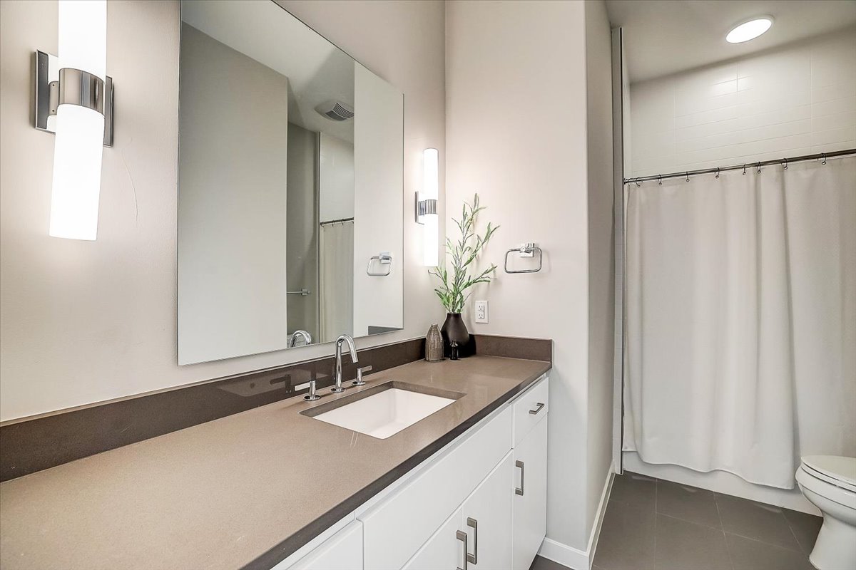 5921 Hiline Road, Unit 1204 Austin, TX 78734 - Photo 21 of 36 Bathroom featuring vanity and dark tile patterned flooring