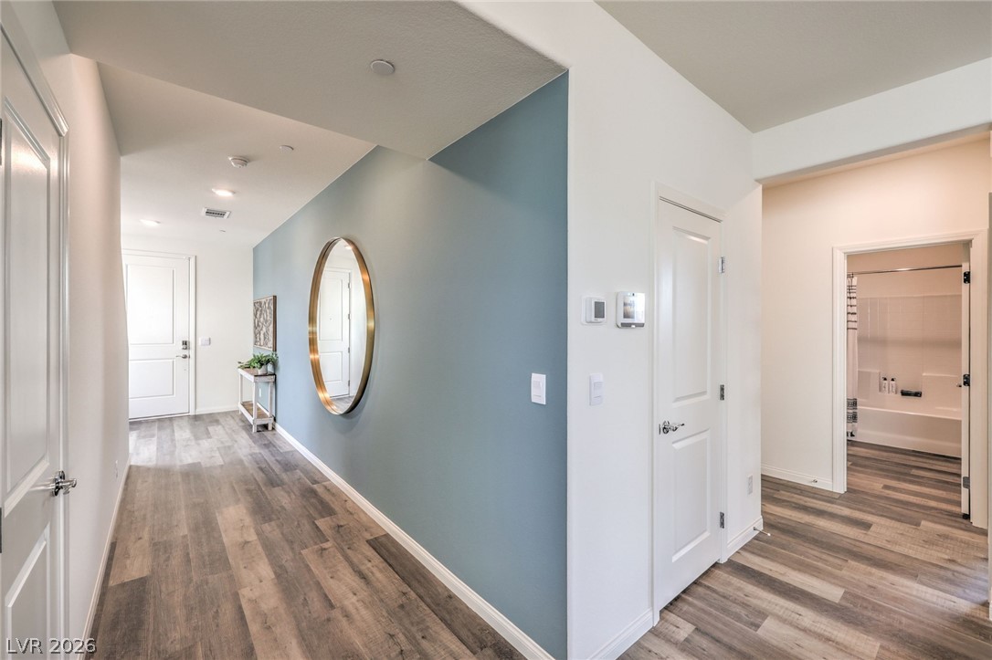 1017 Copper Robin Street Henderson, NV 89011 - Photo 6 of 43 Corridor with wood finished floors, baseboards, and recessed lighting