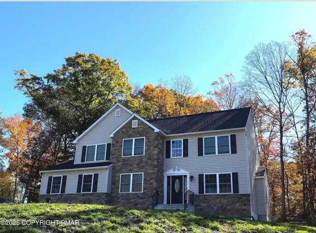 a front view of a house with a yard