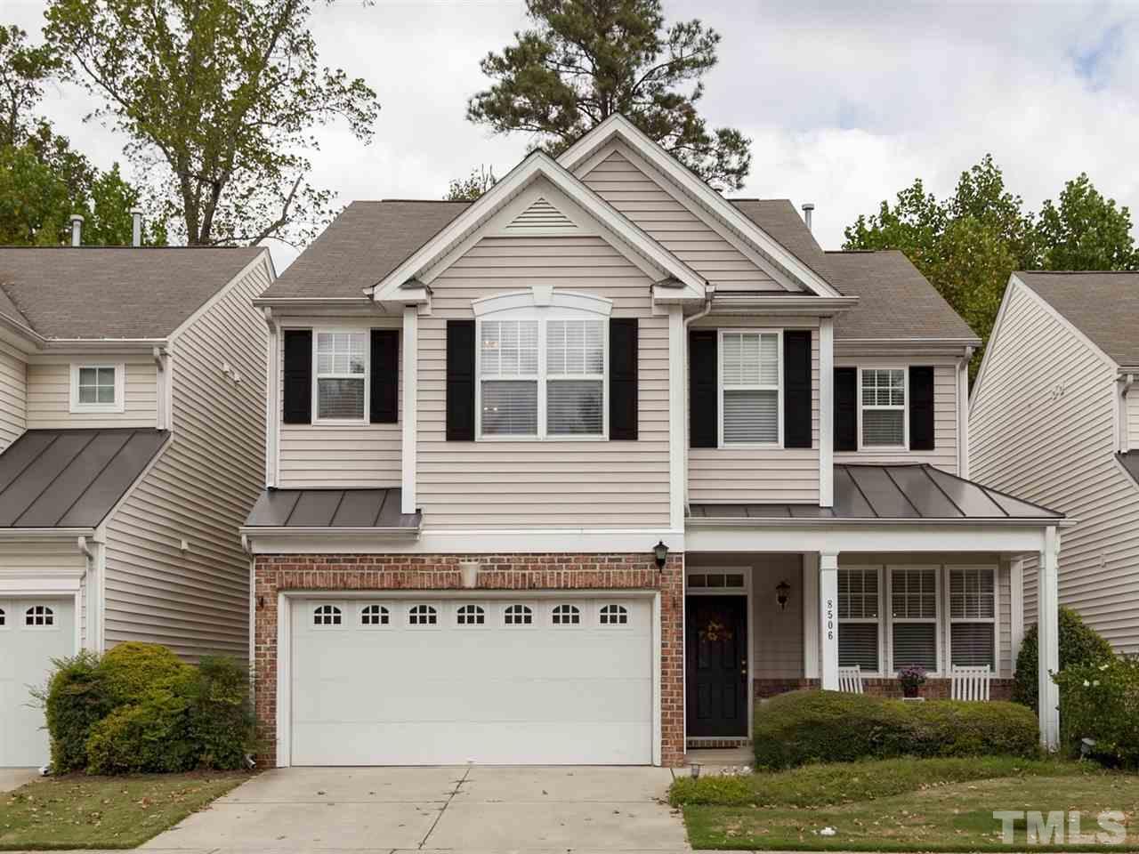 8506 Slabstone Court Raleigh, NC 27613 - Photo 1 of 25 a front view of a house with a garden