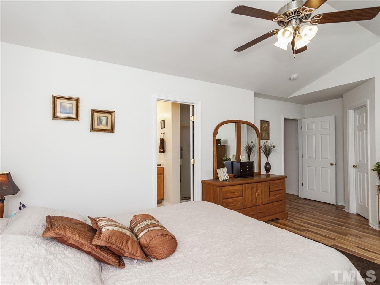 8506 Slabstone Court Raleigh, NC 27613 - Photo 13 of 25 a bedroom with a bed and a large mirror