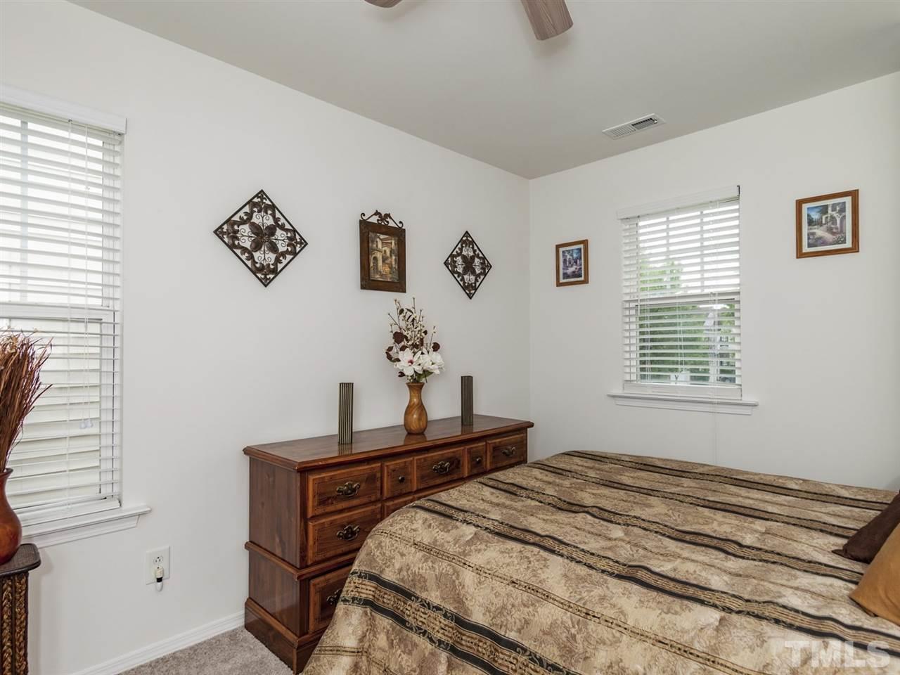 8506 Slabstone Court Raleigh, NC 27613 - Photo 20 of 25 a bedroom with a bed and a window