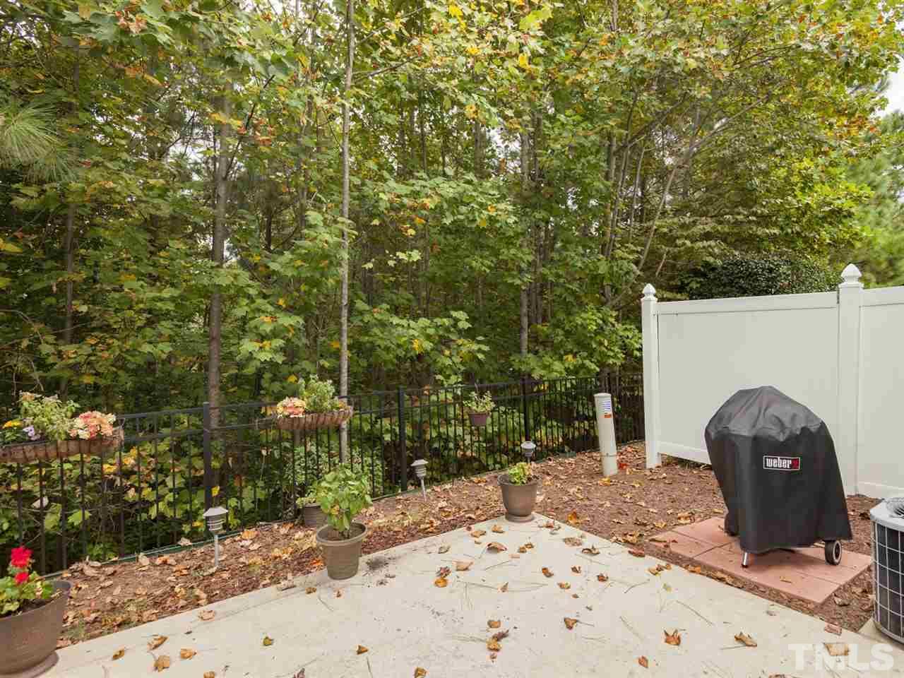 8506 Slabstone Court Raleigh, NC 27613 - Photo 24 of 25 a backyard of a house with lots of green space