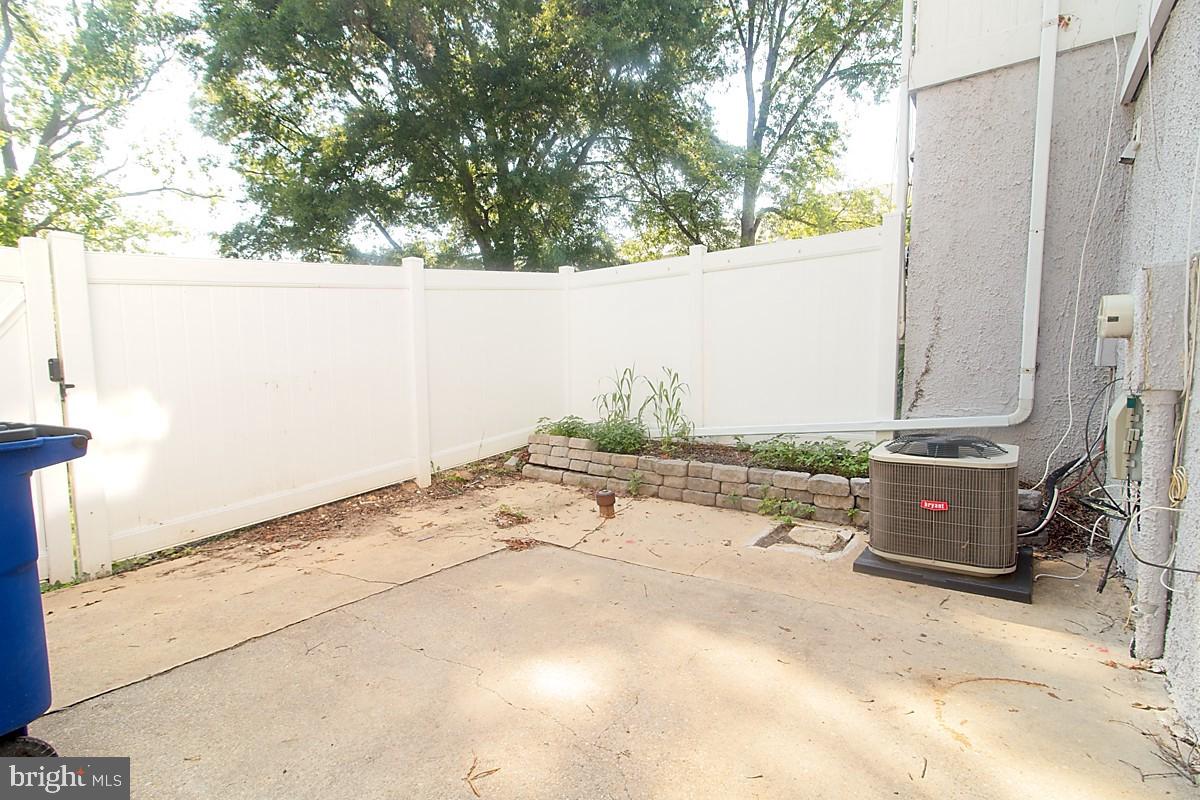 9054 Canterbury Riding, Unit 147 Laurel, MD 20723 - Photo 14 of 15 a backyard of a house with table and chairs