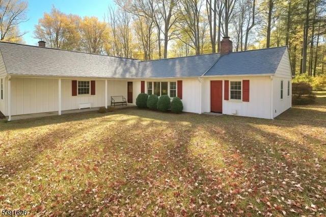 a front view of house with yard and trees
