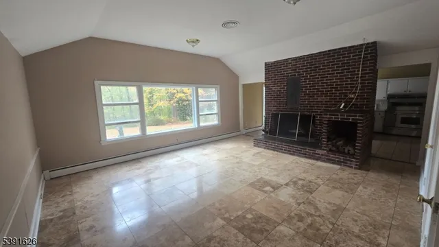 a view of empty room with a fireplace