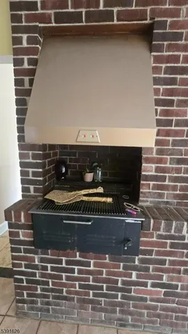 a kitchen with stainless steel appliances a stove a refrigerator a oven a sink with island and chairs