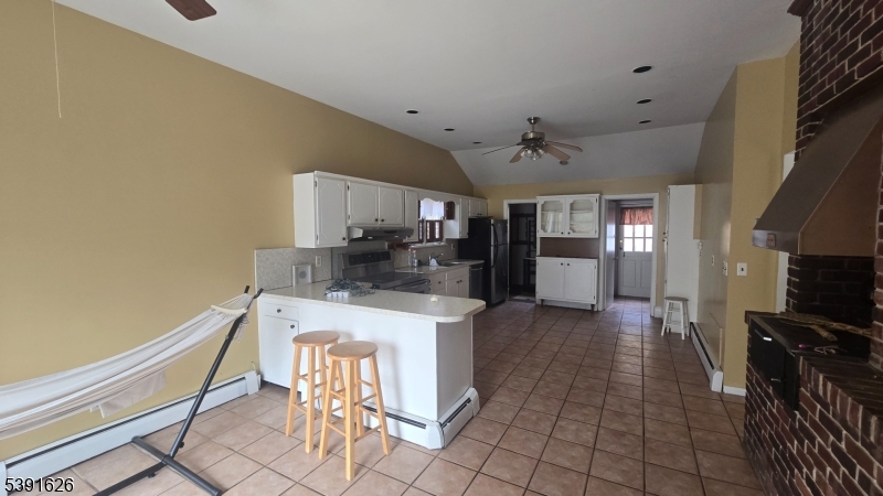 62 Gaston Road Morristown, NJ 07960 - Photo 5 of 23 a kitchen with stainless steel appliances a stove a refrigerator a oven a sink with island and chairs