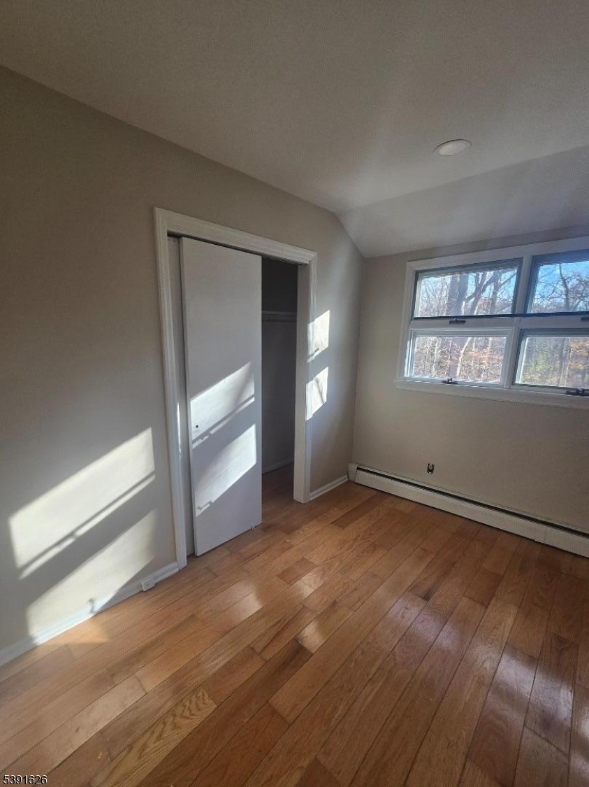 62 Gaston Road Morristown, NJ 07960 - Photo 9 of 23 an empty room with wooden floor and windows