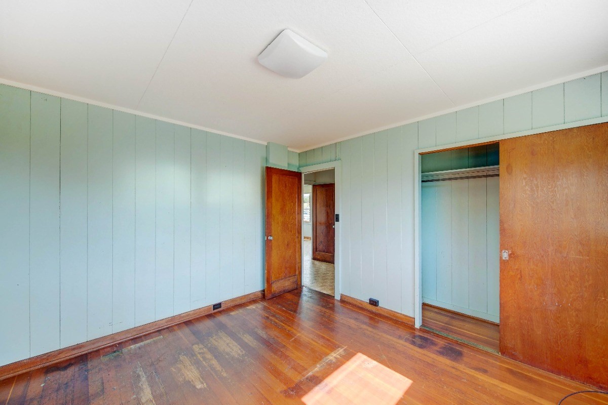 4733 Uliuli Road Eleele, HI 96705 - Photo 11 of 25 an empty room with wooden floor and closet