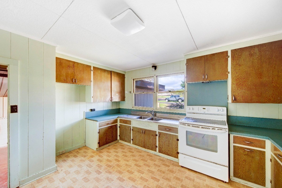 4733 Uliuli Road Eleele, HI 96705 - Photo 6 of 25 a kitchen with a stove sink and cabinets