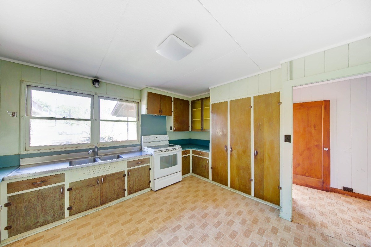 4733 Uliuli Road Eleele, HI 96705 - Photo 7 of 25 a kitchen with a stove a sink and a refrigerator