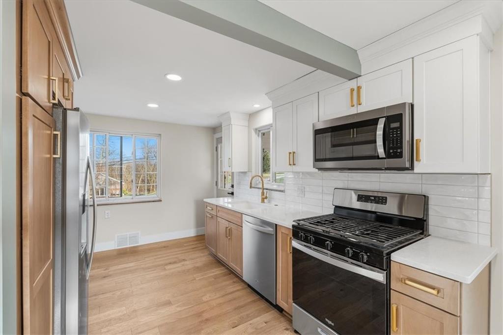 44 Ruthfred Drive Pittsburgh, PA 15241 - Photo 10 of 29 a kitchen with stainless steel appliances a sink stove and microwave