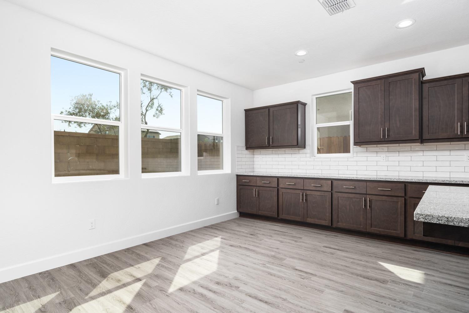 321 Peters Road Madera, CA 93636 - Photo 22 of 33 a kitchen with stainless steel appliances granite countertop a stove a sink and a microwave