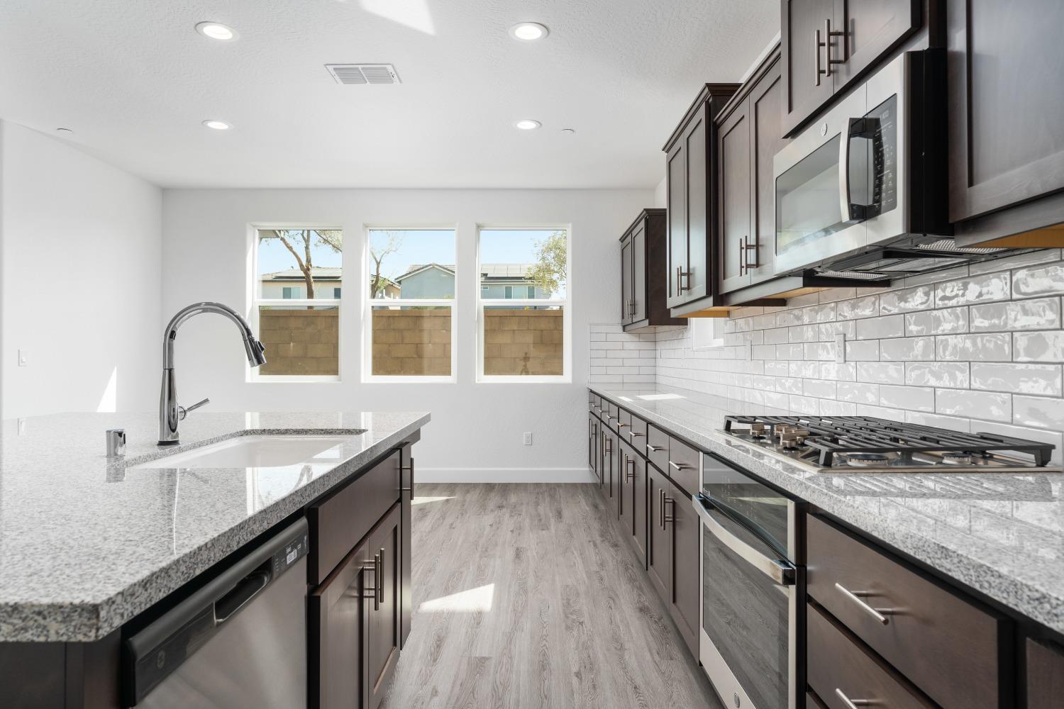 321 Peters Road Madera, CA 93636 - Photo 24 of 33 a kitchen that has a sink and a stove