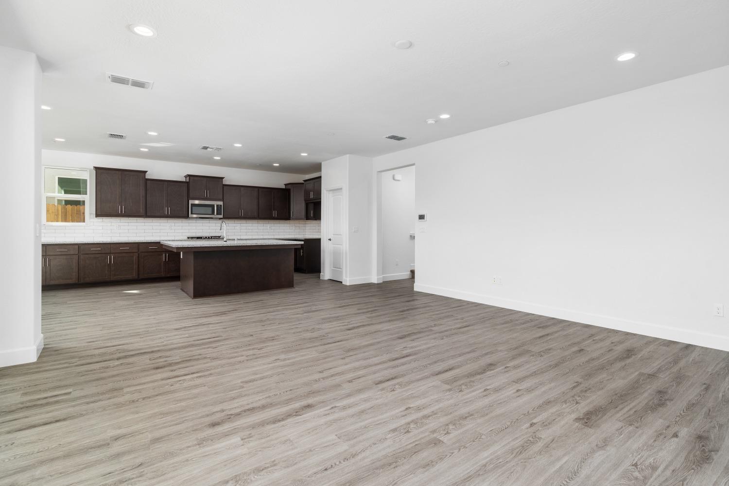 321 Peters Road Madera, CA 93636 - Photo 32 of 33 a large kitchen with stainless steel appliances a large counter top a stove a sink and a refrigerator