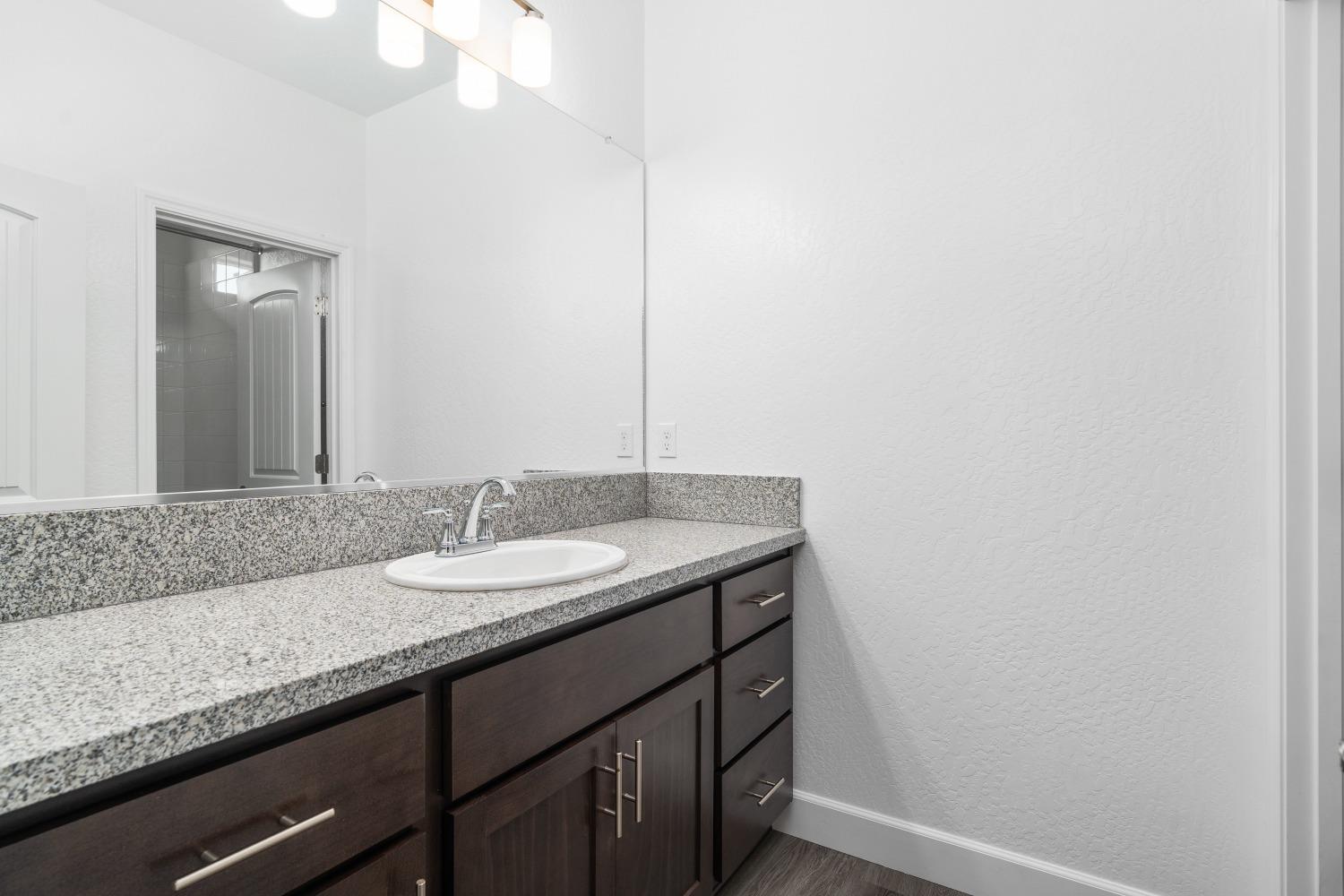 321 Peters Road Madera, CA 93636 - Photo 8 of 33 a bathroom with a granite countertop sink and a mirror