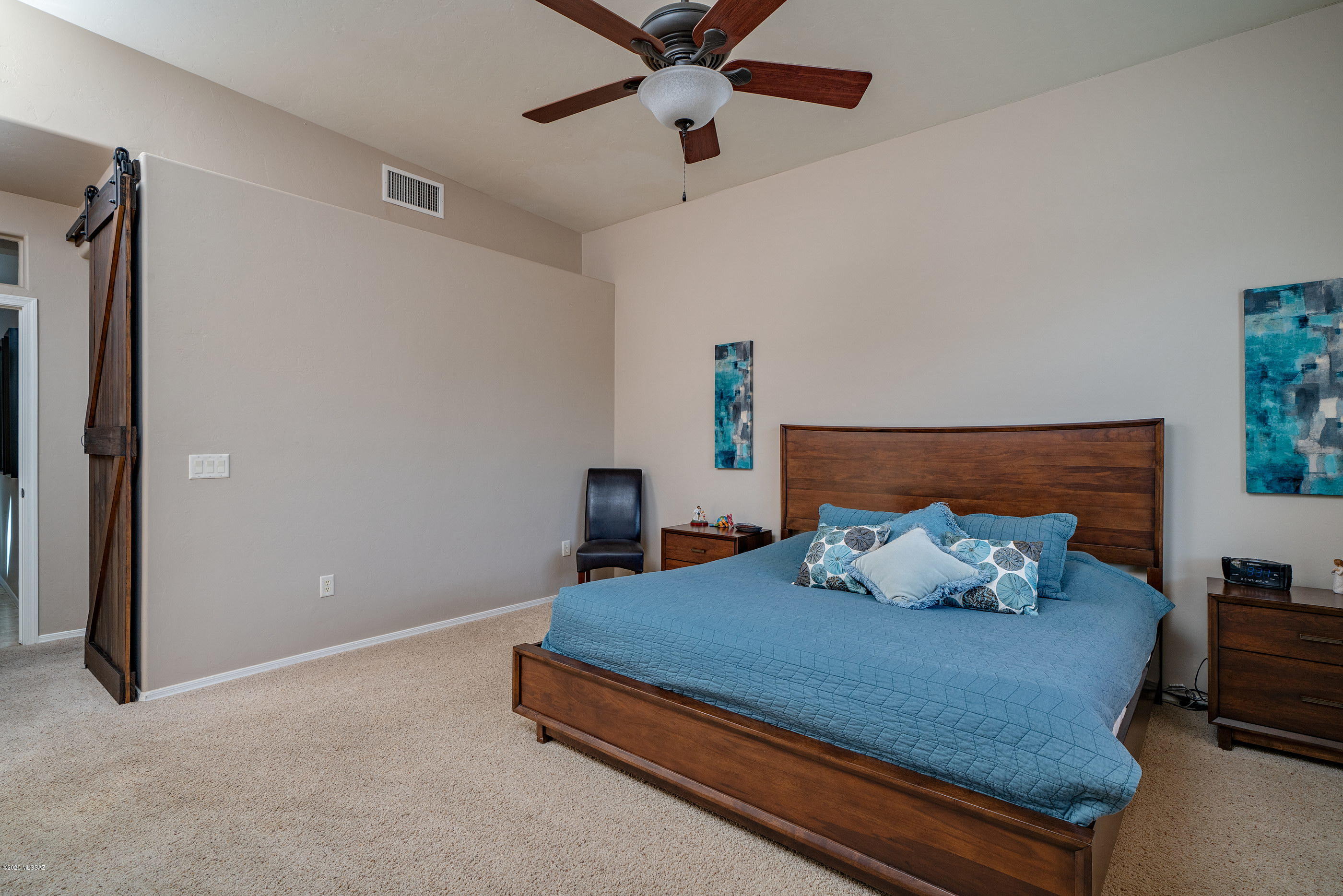4440 West Crystal Ranch Place Marana, AZ 85658 - Photo 25 of 28 a bedroom with a bed and ceiling fan