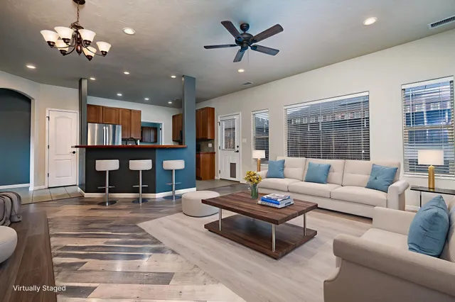 a living room with fireplace furniture and a chandelier