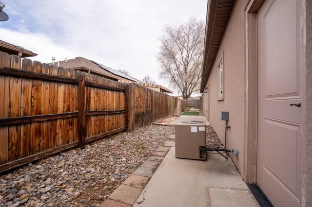 a view of a pathway gate with wooden fence