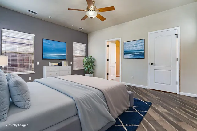 a bedroom with a bed dresser and a window