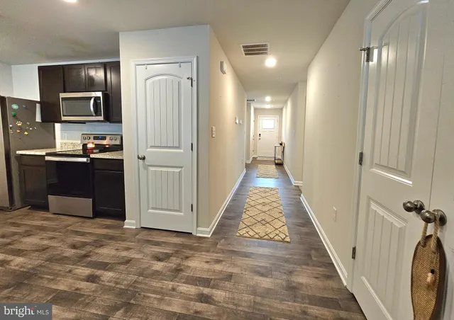 a view of a kitchen with a sink and refrigerator