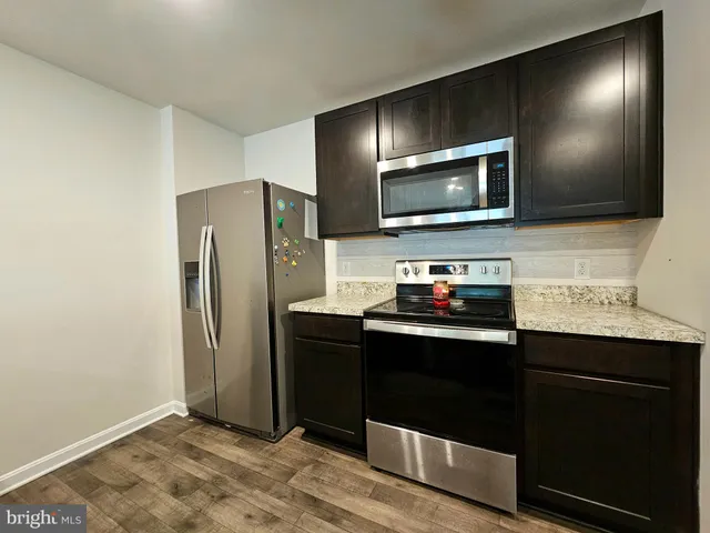 a kitchen with stainless steel appliances a refrigerator and a sink
