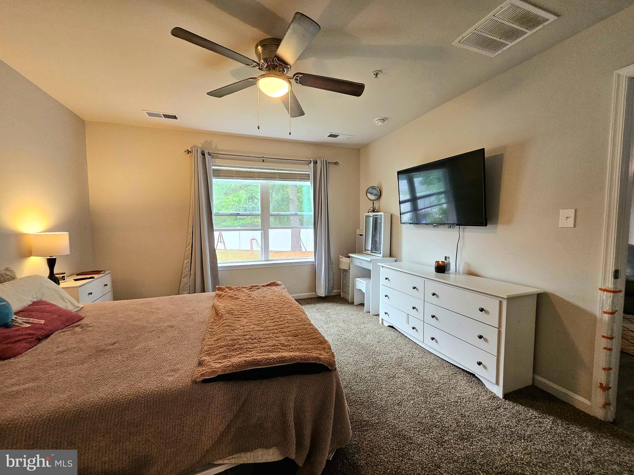415 Creekside Trail Fruitland, MD 21826 - Photo 27 of 41 a bedroom with a bed and a flat screen tv on dresser