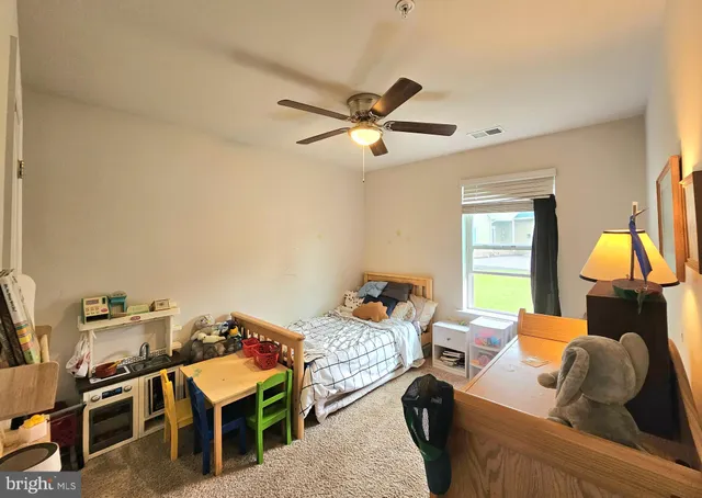 a bedroom with furniture and a window