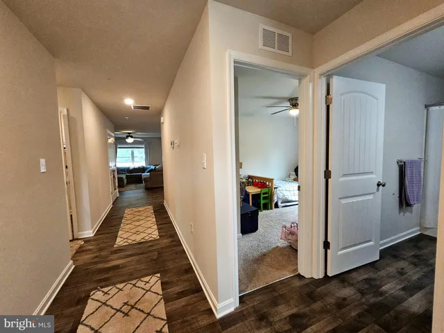 a view of a hallway with living room