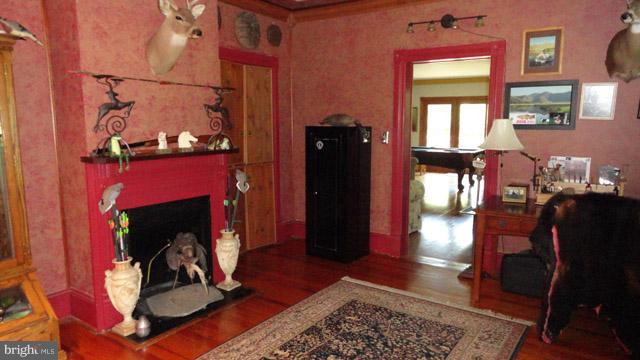 837 Leetown Road Summit Point, WV 25446 - Photo 11 of 30 a living room with a fireplace windows and a rug