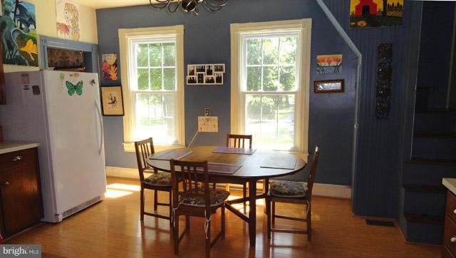 837 Leetown Road Summit Point, WV 25446 - Photo 12 of 30 a view of a dining room with furniture and wooden floor