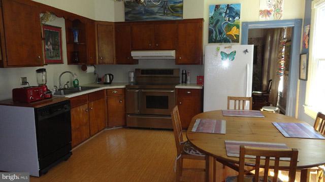 837 Leetown Road Summit Point, WV 25446 - Photo 13 of 30 a kitchen with stainless steel appliances granite countertop a refrigerator a stove top oven a sink and dishwasher