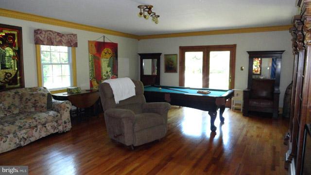 837 Leetown Road Summit Point, WV 25446 - Photo 16 of 30 a living room with furniture and a wooden floor