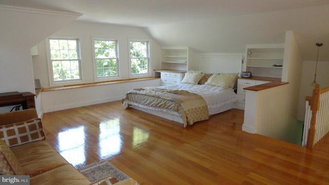 837 Leetown Road Summit Point, WV 25446 - Photo 17 of 30 a spacious bedroom with a bed a dresser and a large window