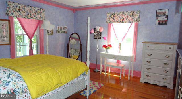 837 Leetown Road Summit Point, WV 25446 - Photo 19 of 30 a bed sitting in a bedroom next to a window