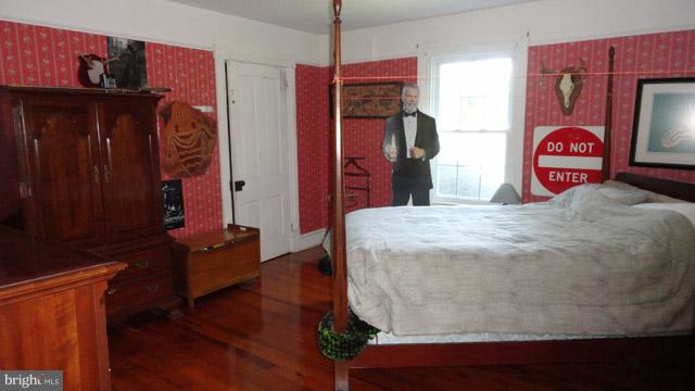 837 Leetown Road Summit Point, WV 25446 - Photo 20 of 30 a bedroom with a bed and wooden floor