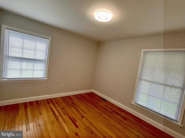 a view of room with window and wooden floor