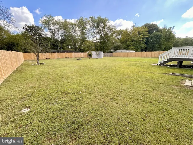 a backyard of a house with a yard and outdoor seating