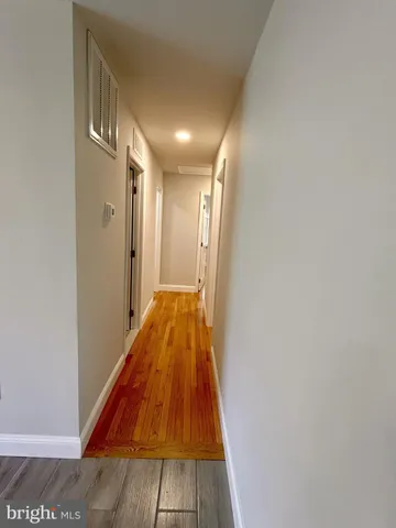 a view of a hallway with a door