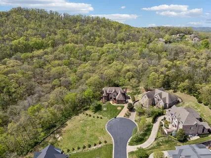 an aerial view of a residential houses with outdoor space and street view