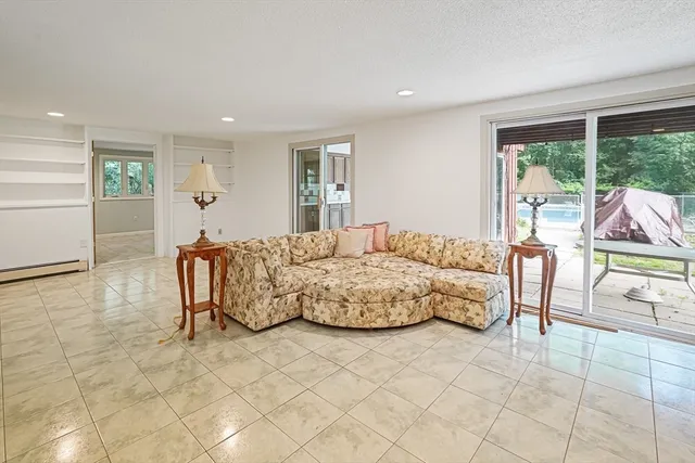 a spacious bedroom with a bed a table and chair