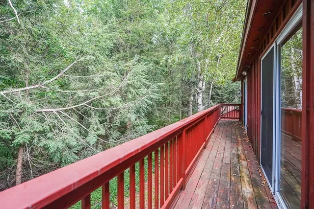 a view of balcony with wooden floor and fence