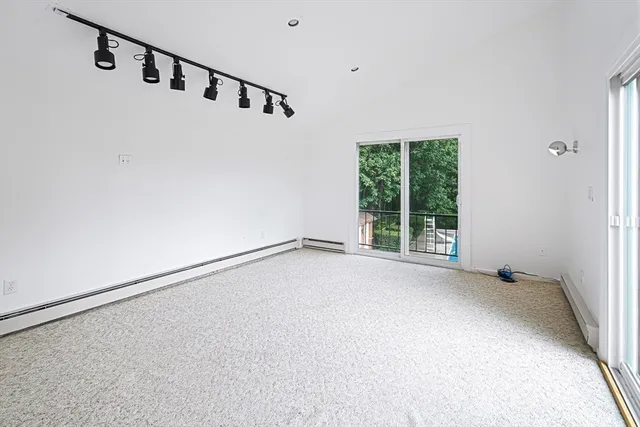 a view of an empty room with windows