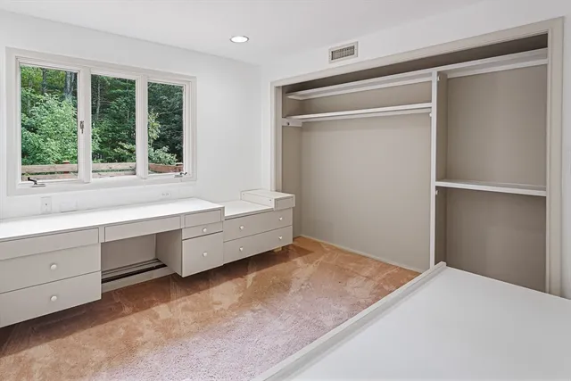 a room with a bed and a window